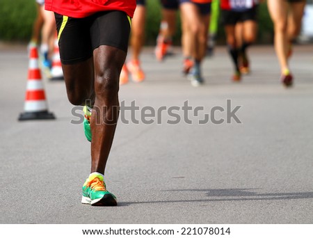 fast athlete runs down the street during the race outdoors