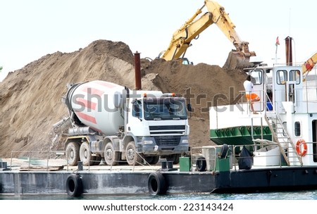 cement mixer in the construction site by the sea for the construction of a massive dam