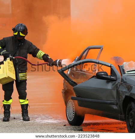 brave firefighter with helmet off the car burned