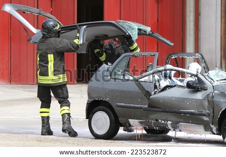Firefighters open the hood of the car accident after accident