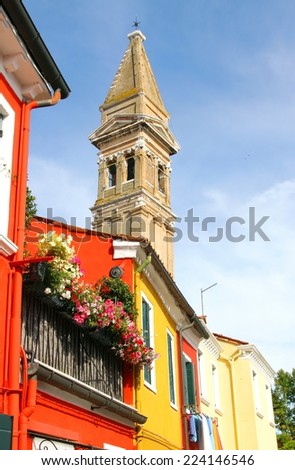 red house and church tower of BURANO near Venice in Italy