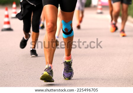 knee bandaged by medical bandage runner during sport competition