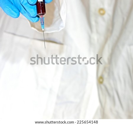 syringe with human blood taken to carry out an analysis in chemical laboratory