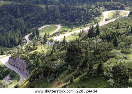 winding uphill road with many bends in the mountains