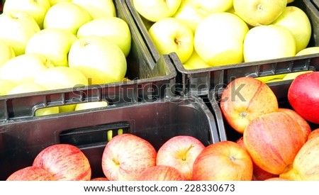 boxes of red and yellow apples on sale at the local market