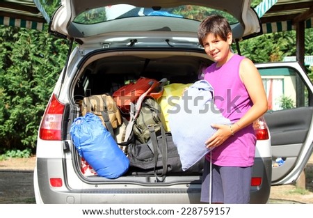 young boy car baggage charge before departure