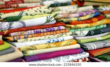 lots of colored cloth tablecloths for sale in the town market