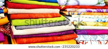 lots of colored cloth tablecloths for sale in the market