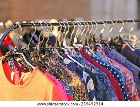 Many vintage style clothes  for sale at an outdoor flea market