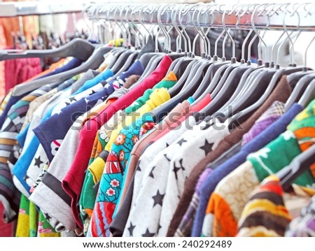 set of vintage clothes of many colors at flea market