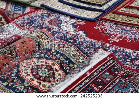 many colourful Oriental rugs for sale in the shop of rugs