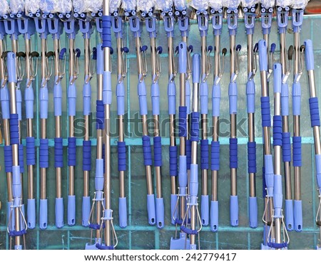 many blue tool handles to wash the glasses of the large Windows of the House for sale at the market