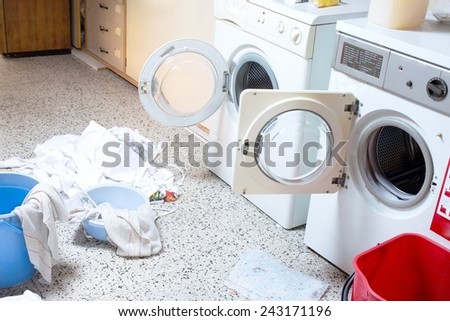 two big washing machines with the dirty laundry in the laundry room of the kindergarten