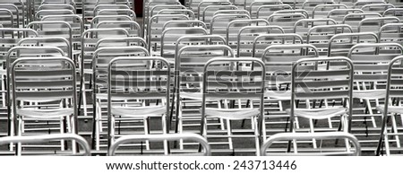 many steel chairs without viewers into an open-air cinema