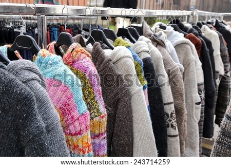 sweaters and vintage clothes for sale in open-air flea market