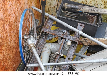 part of a bicycle in the container for the collection of scrap metal
