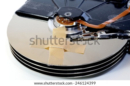 broken hard drives with a band-aid over the disks