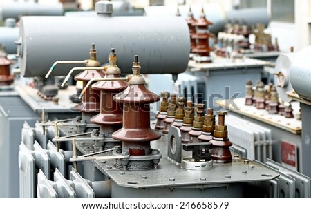 pile of three-phase current transformers in industrial warehouse