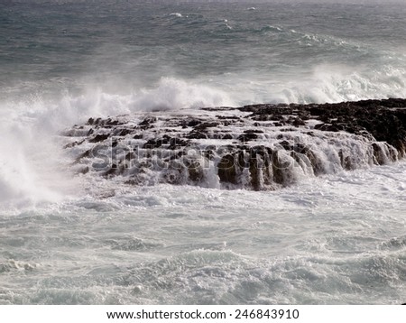 dangerous rock covered by the waves of the sea where ships can wrecked