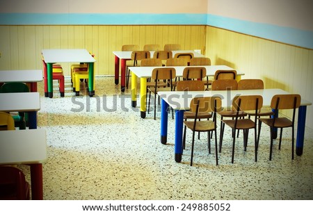 lunchroom of the refectory of the kindergarten with desks and colored chairs