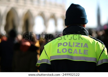 Italian policeman with police uniform patrol in venice in winter