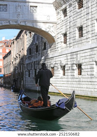 Gondolier on channel of the bridge of sighs in Venice in Italy