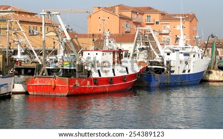 red fishing vessel other ships moored in the harbor of the Mediterranean Sea