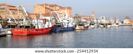 red fishing vessel other ships moored in the harbor of the Mediterranean Sea