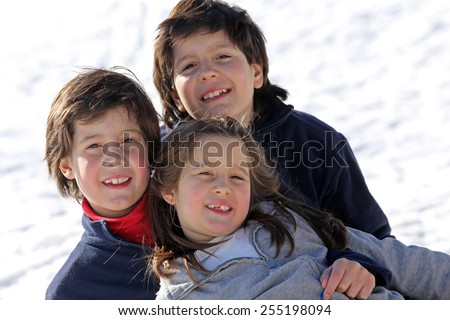 beautiful three brothers in the snow in winter