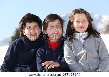 three brothers smile in snow mountain in winter