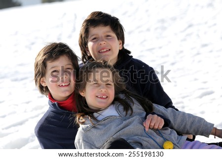 Pretty Three brothers on the snow in the mountains