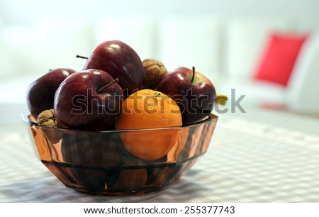 ripe red apples and fruit in the basket above the table