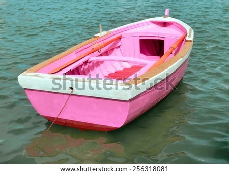 pink boat in the middle of the sea