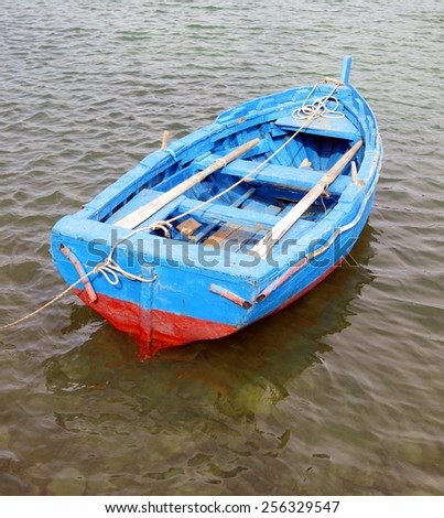 blue and red boat in the middle of the sea