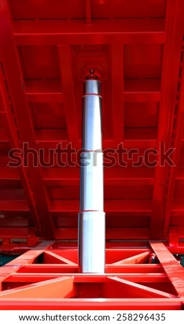 big stainless steel Hydraulic cylinder ton below the red caisson tipper truck