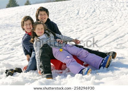 Three brothers on the snow in the mountains in winter