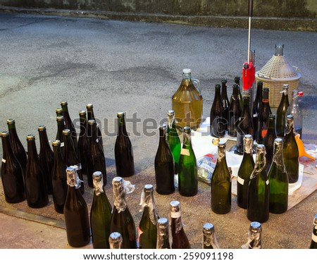 pour the wine in the backyard with the Carboy and glass bottles