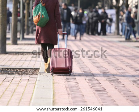 smart career woman during a business trip with the trolley in public park