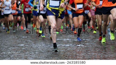 group of runners during marathon while it is raining, motion blur