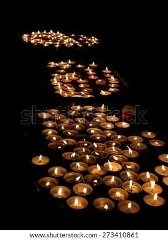 many lit candles at mass in church