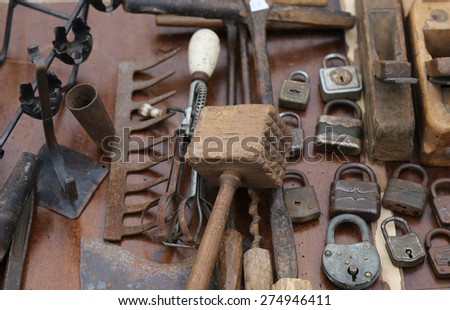 wooden hammer and rusty padlocks and planers in the workshop of flea market