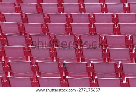 empty red chairs of iron before the musical concert