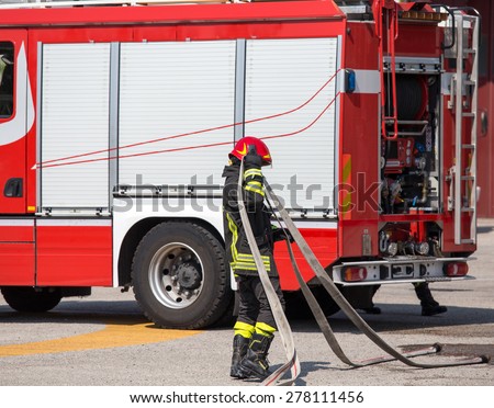 firefighters with the hose to put out the fires and the great firetruck