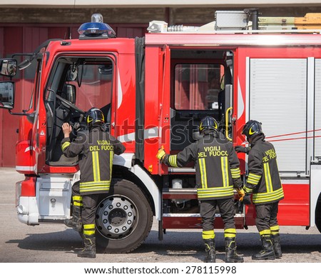 fast Italian firefighters climb on firetrucks during an emergency