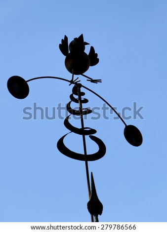 wind vane in the shape of a bird with spiral