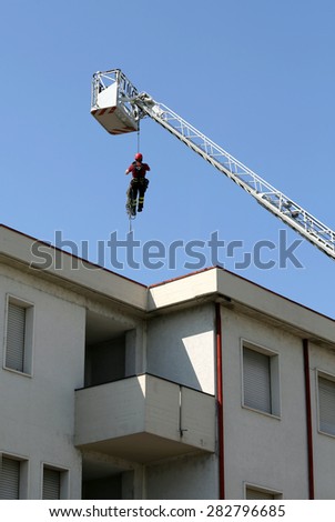 expert firefighter down with the rope in the building during a fire alarm in the fire station