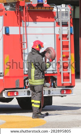Firefighter lifted the Red hose after put off the fire
