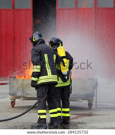 firefighters with oxygen bottles off the fire during a training exercise in the fire station
