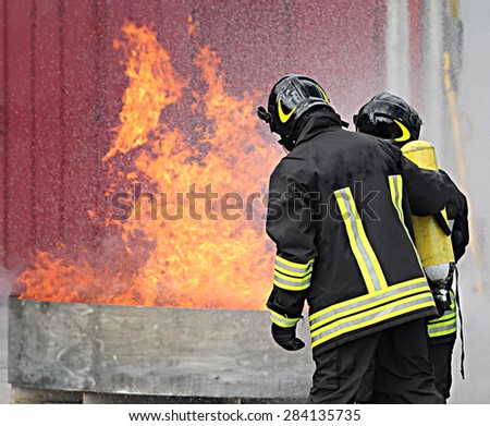 firefighters with oxygen bottles off the fire during a training exercise