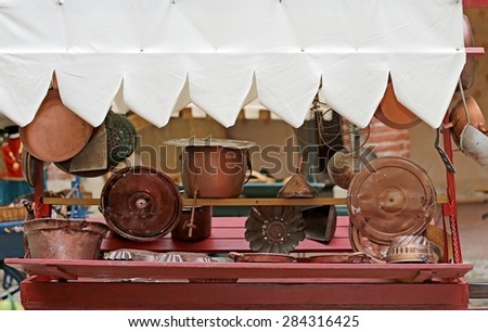 many copper objects for kitchen and home for sale in the antiques stall at flea market